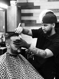 a man getting his hair cut in a barber shop